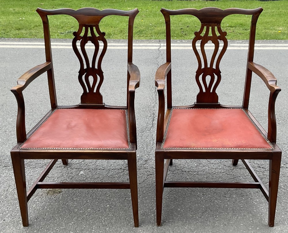 A set of eight Edwardian mahogany dining chairs featuring pierced back splats, square legs with stretchers, and red leather seats detailed with brass studding. View IV