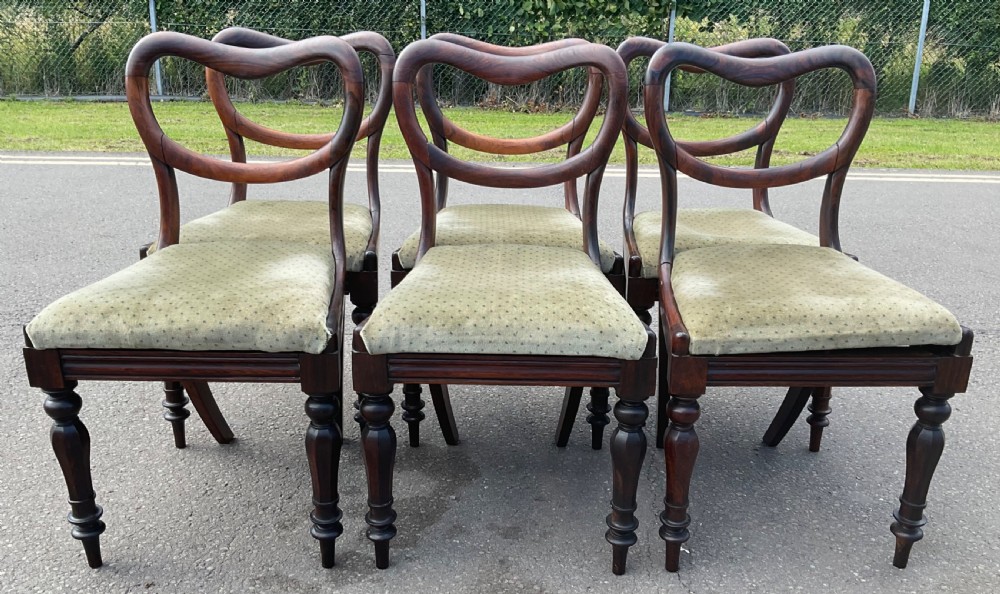 A set of six Victorian rosewood balloon back dining chairs with green velvet upholstered seats and turned front legs. View III