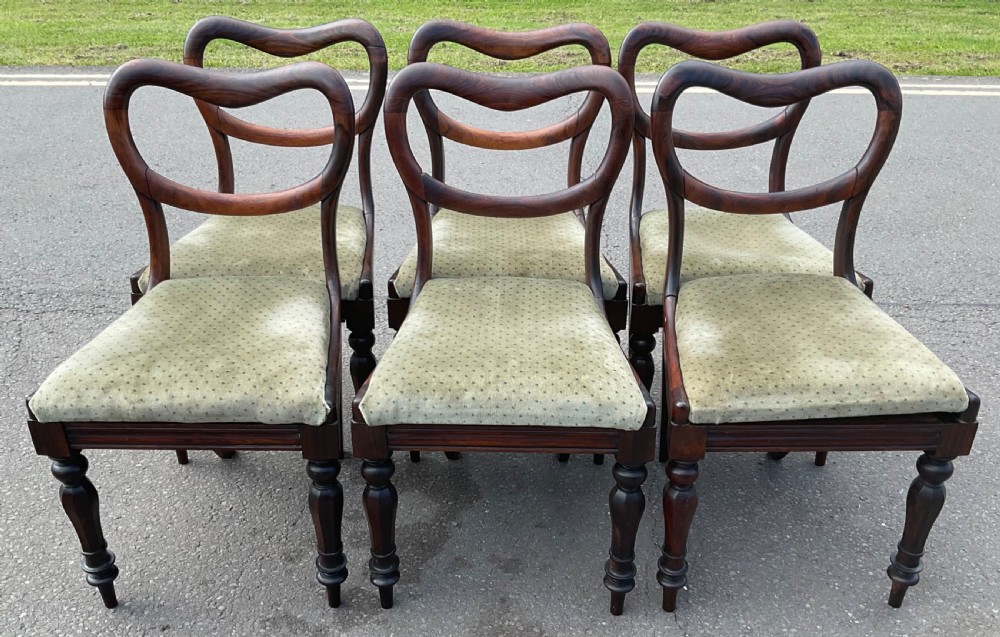 A set of six Victorian rosewood balloon back dining chairs with green velvet upholstered seats and turned front legs. View V