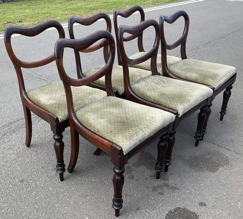 A set of six Victorian rosewood balloon back dining chairs with green velvet upholstered seats and turned front legs. View VII