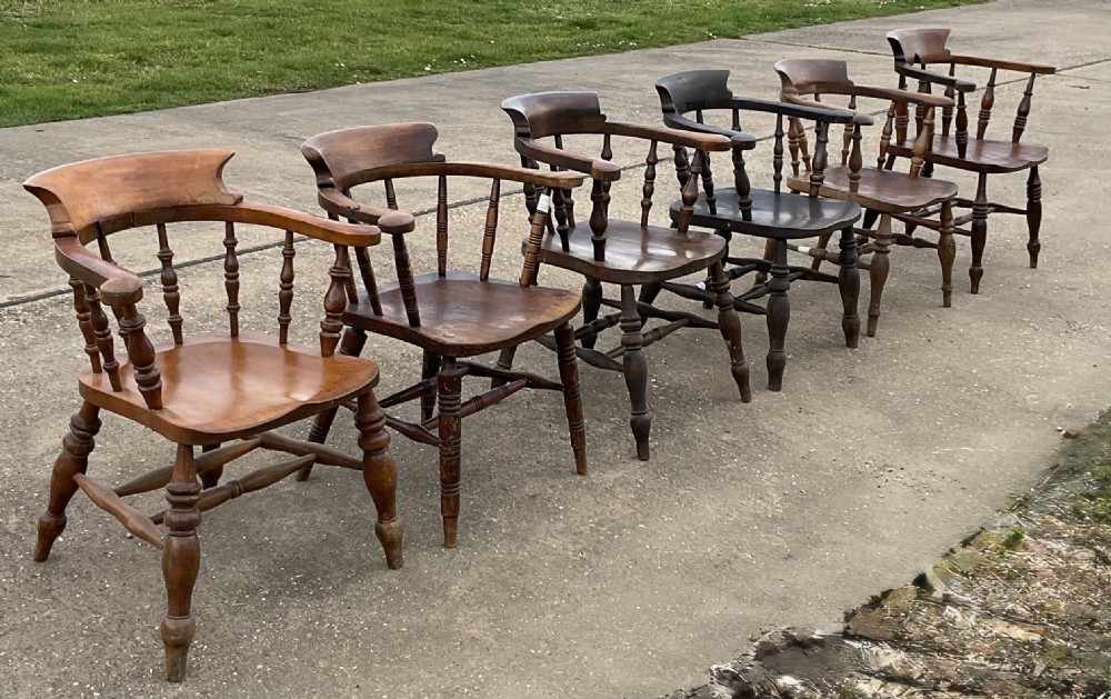A set of six Victorian smokers bow armchairs with turned spindles, contoured saddle seats, and H-stretchers. View II