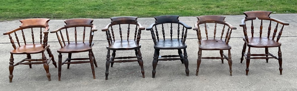 A set of six Victorian smokers bow armchairs with turned spindles, contoured saddle seats, and H-stretchers. View III