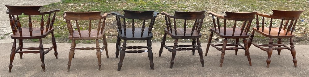 A set of six Victorian smokers bow armchairs with turned spindles, contoured saddle seats, and H-stretchers. View VIII