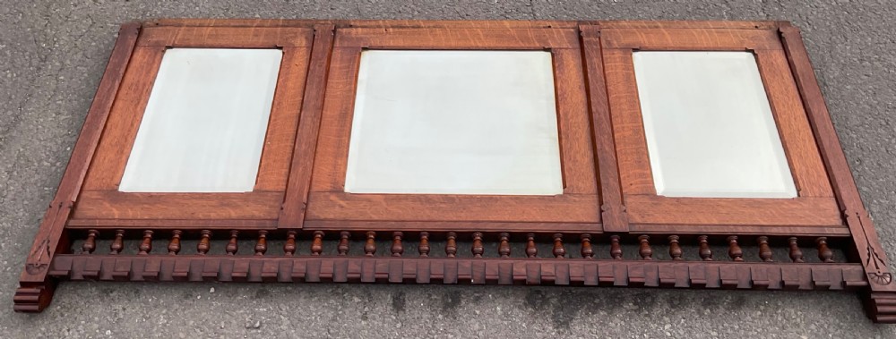 A large Victorian Gothic quarter-sawn oak overmantel mirror featuring three mirror panels and a decorative spindle gallery along the top rail. View V