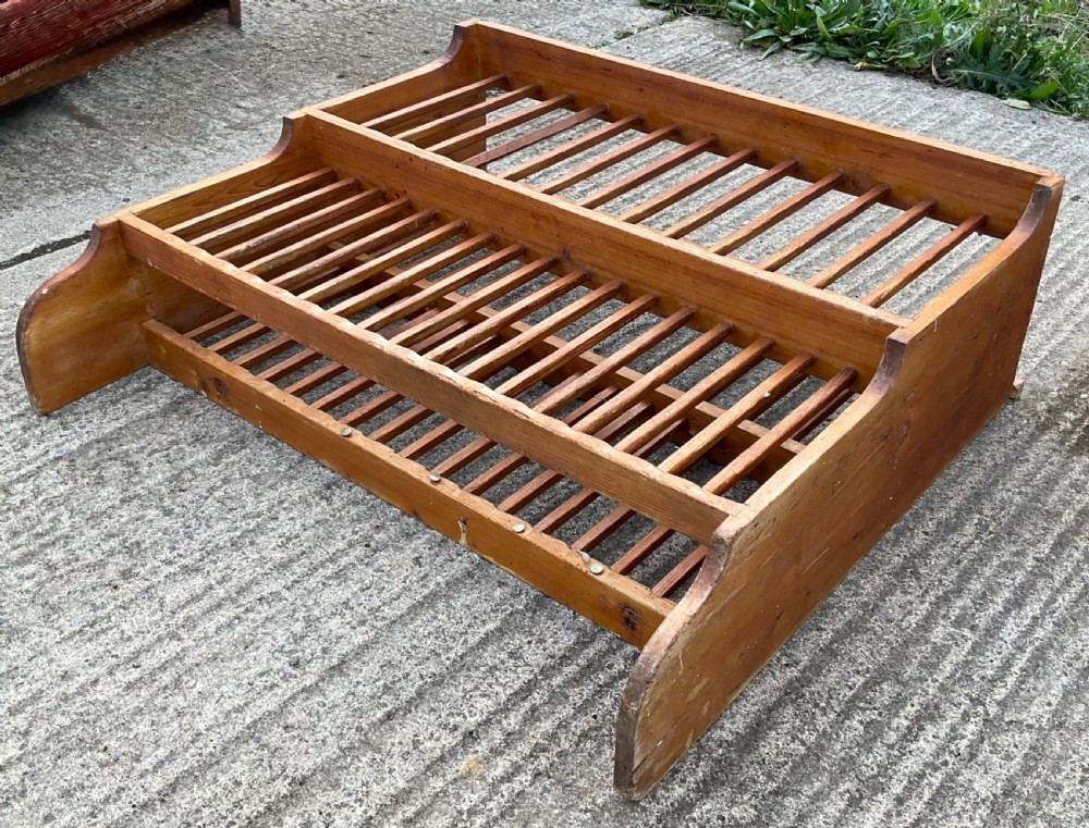 A two-tiered pine hanging kitchen plate rack featuring slatted timber shelves and curved side supports. View II