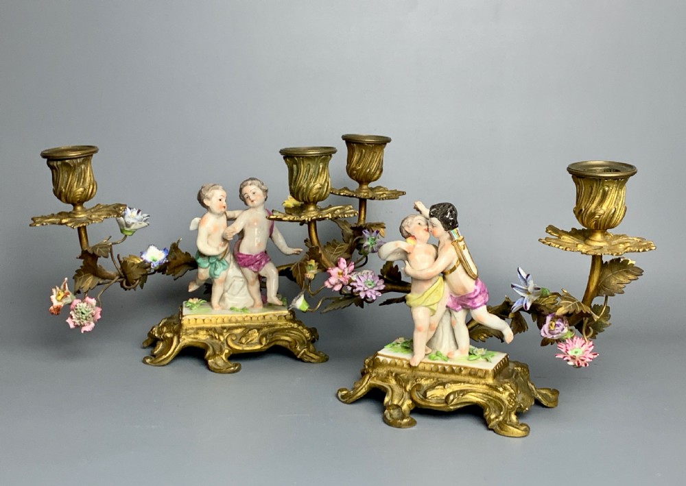 Pair of Continental porcelain ormolu mounted candelabra with cherubs