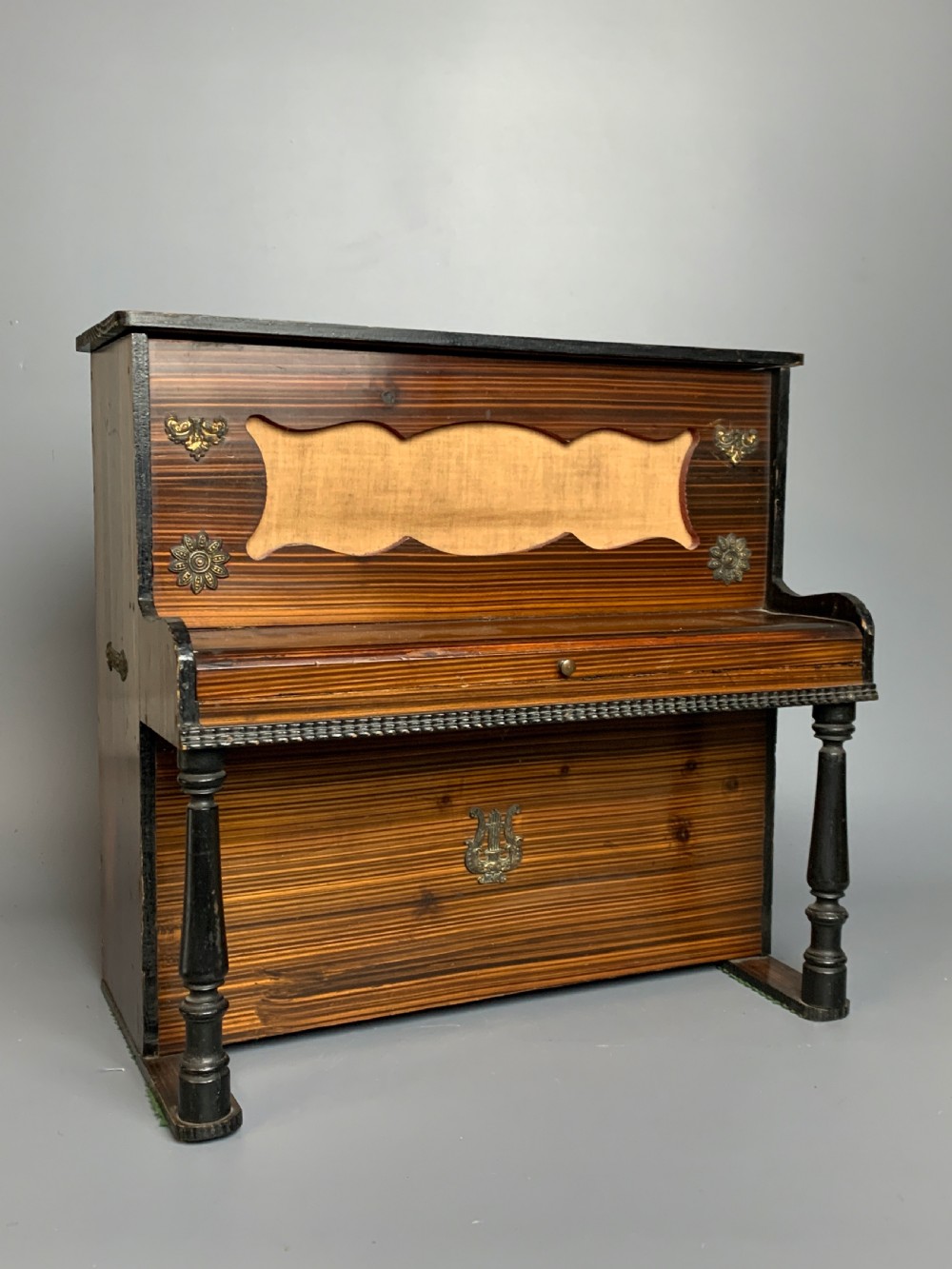 Antique German child's toy piano with faux bois case, circa 1910