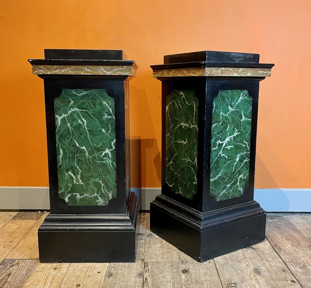 Pair of faux marble painted pedestals with black slate tops