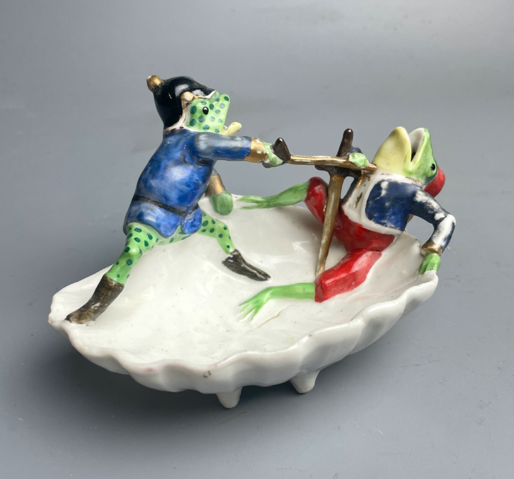 Continental novelty porcelain dish of two frogs sword fighting fairing