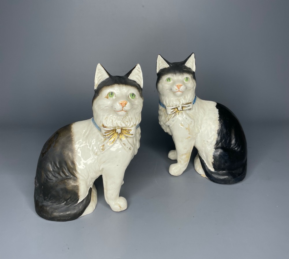 Pair of Continental pottery black & white seated cats