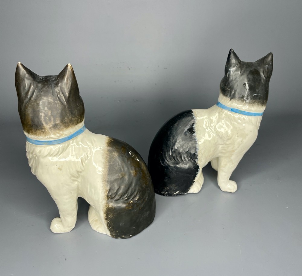 Pair of Continental pottery black & white seated cats View III