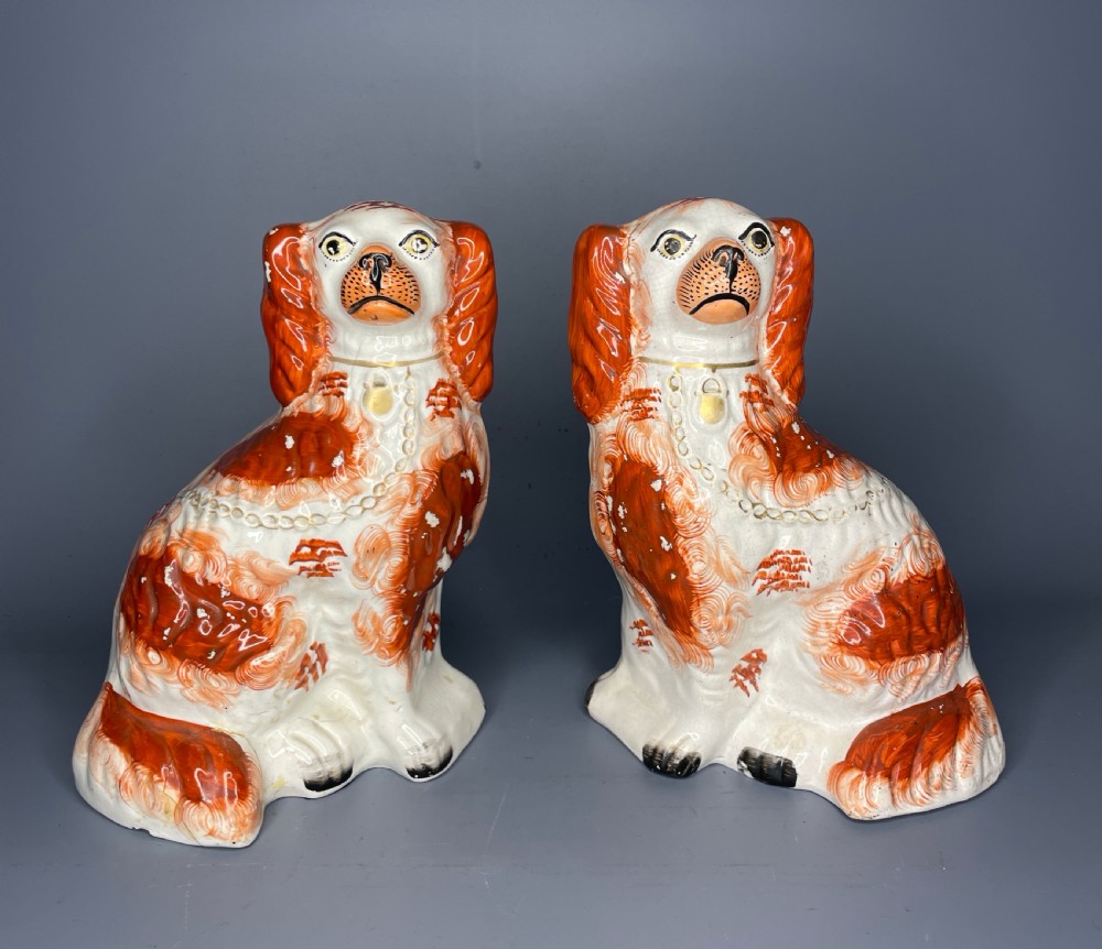 Pair of Staffordshire Pottery Spaniels with tan and white coats