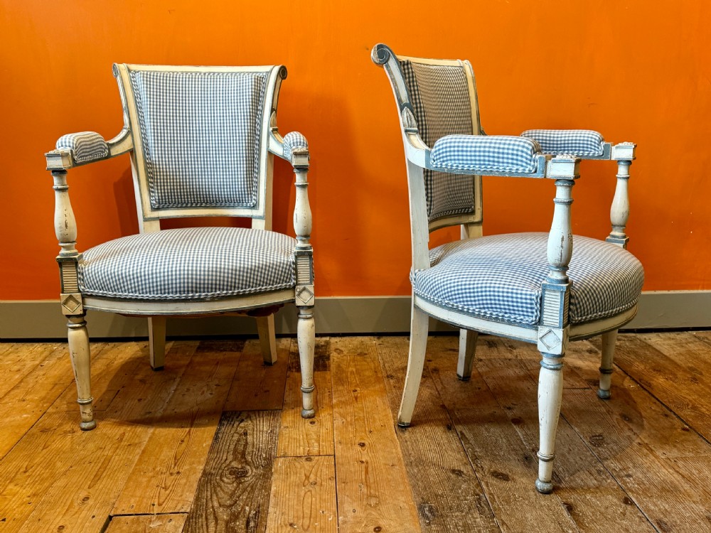 Pair of vintage French armchairs featuring off-white distressed painted frames, fluted turned front legs, and blue and white checked fabric upholstery. View IV