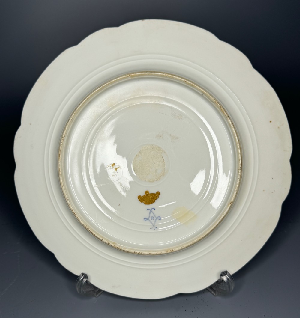 A circular 19th-century French porcelain cabinet plate featuring central hand-painted floral bouquets framed by elaborate gold scrollwork and a turquoise border. View VI