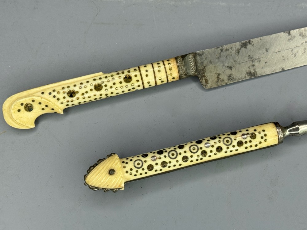 A 19th-century Balkan knife and fork set featuring carved cream bone handles with inlaid circular geometric designs and steel working ends. View II