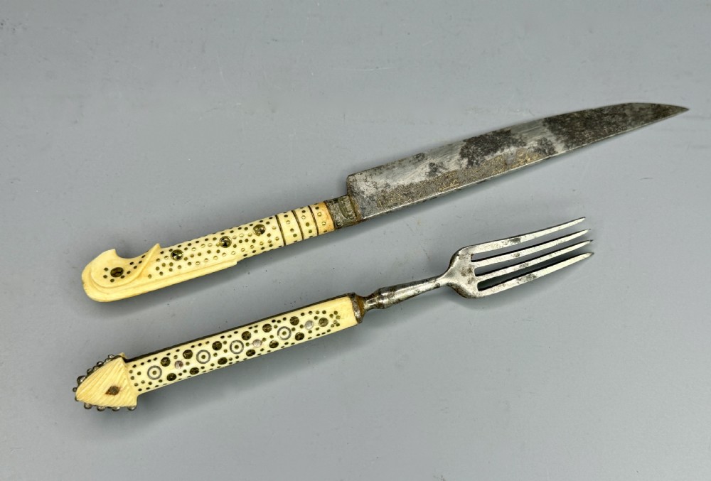 A 19th-century Balkan knife and fork set featuring carved cream bone handles with inlaid circular geometric designs and steel working ends. View III