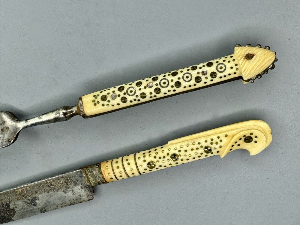 A 19th-century Balkan knife and fork set featuring carved cream bone handles with inlaid circular geometric designs and steel working ends. View IV