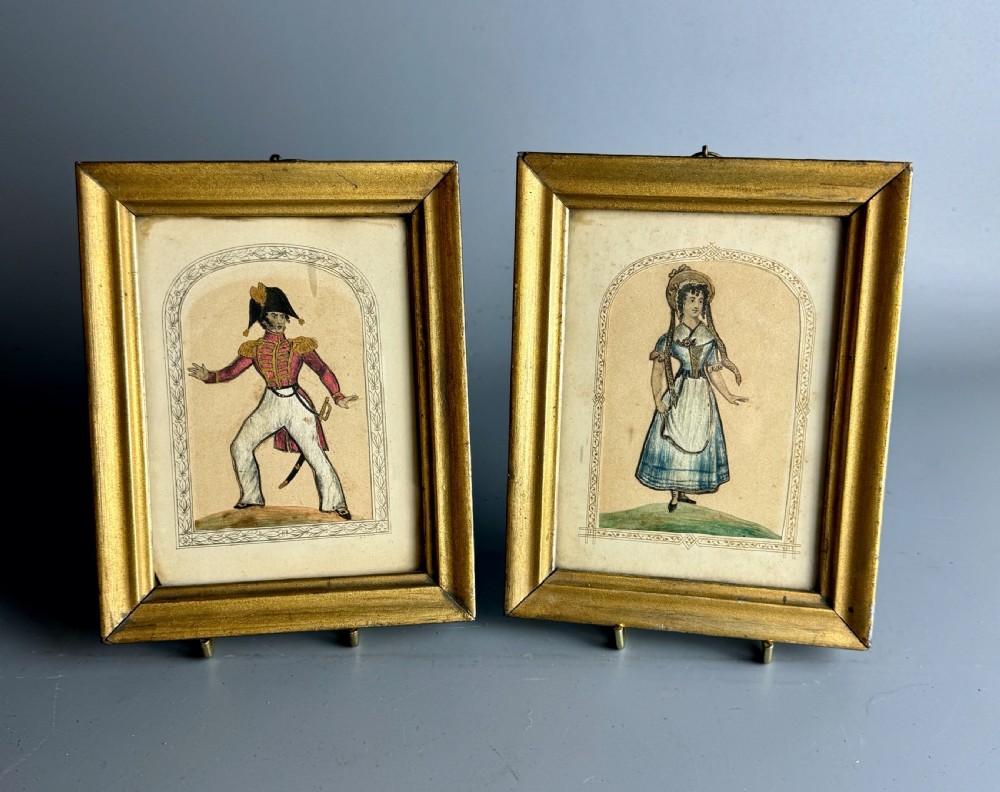 A pair of framed mid-nineteenth-century theatrical silkwork pictures depicting figures in period costume within moulded gilt wooden frames. View II