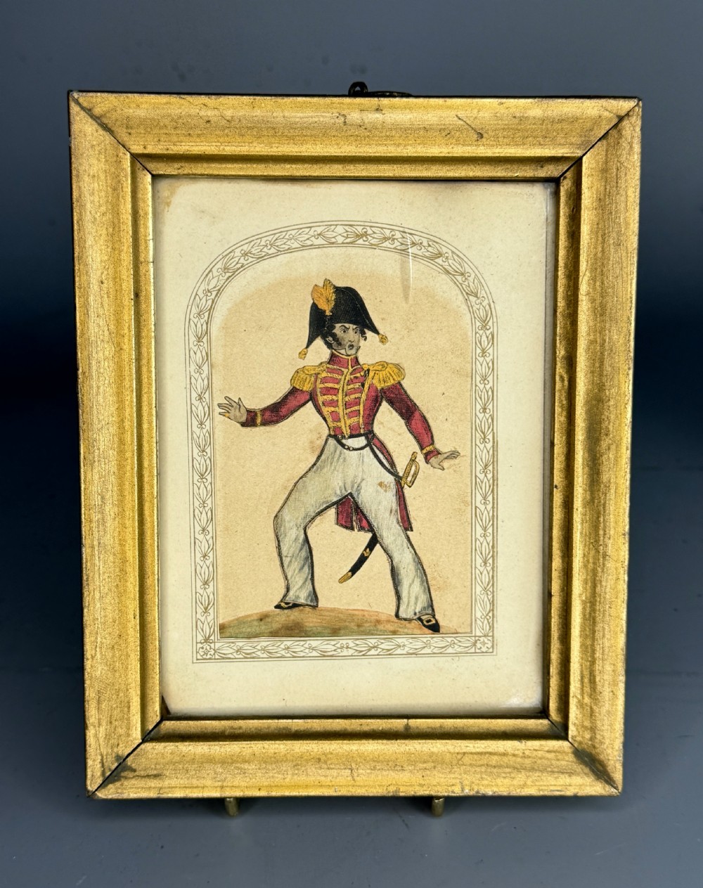 A pair of framed mid-nineteenth-century theatrical silkwork pictures depicting figures in period costume within moulded gilt wooden frames. View V