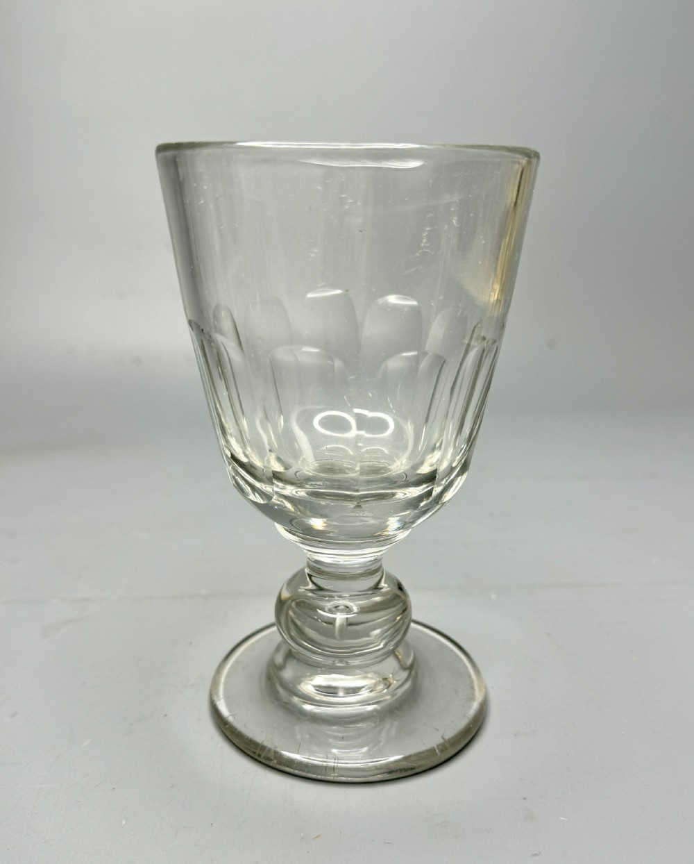 A clear Victorian glass rummer featuring a slice-cut bowl, a knopped stem, and a flat circular base. View II