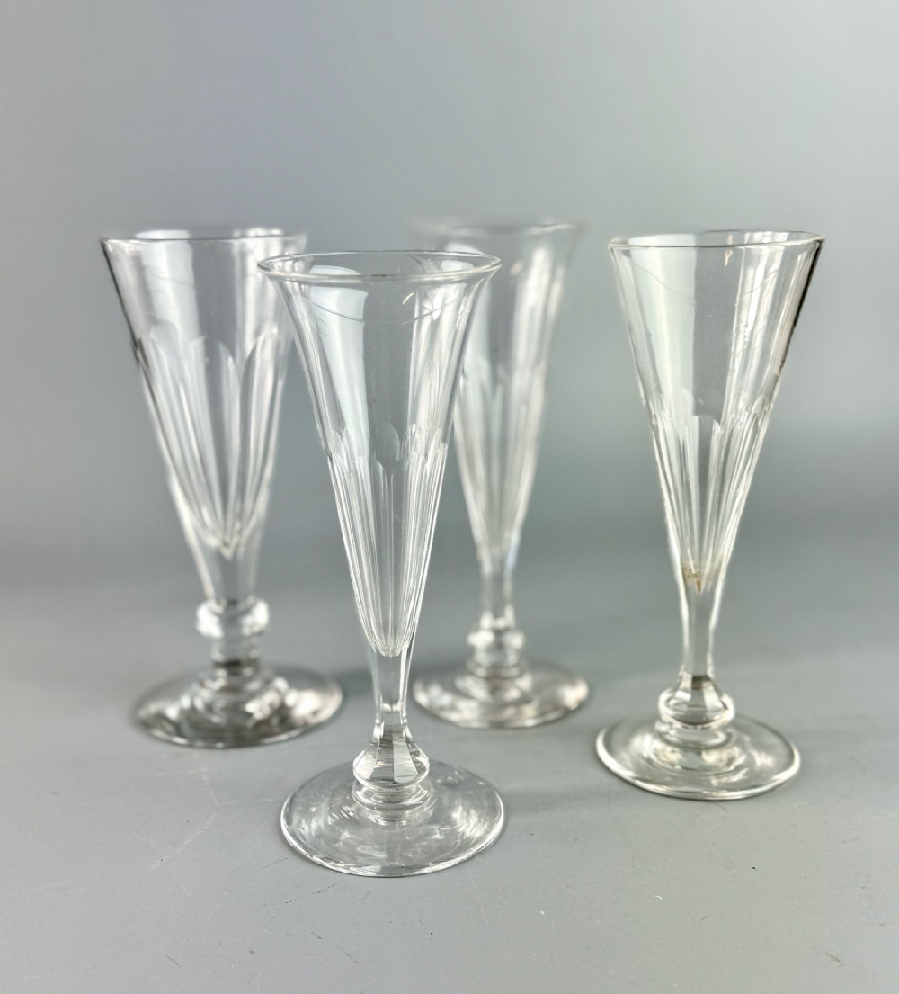 A harlequin set of four antique cut glass champagne flutes View II