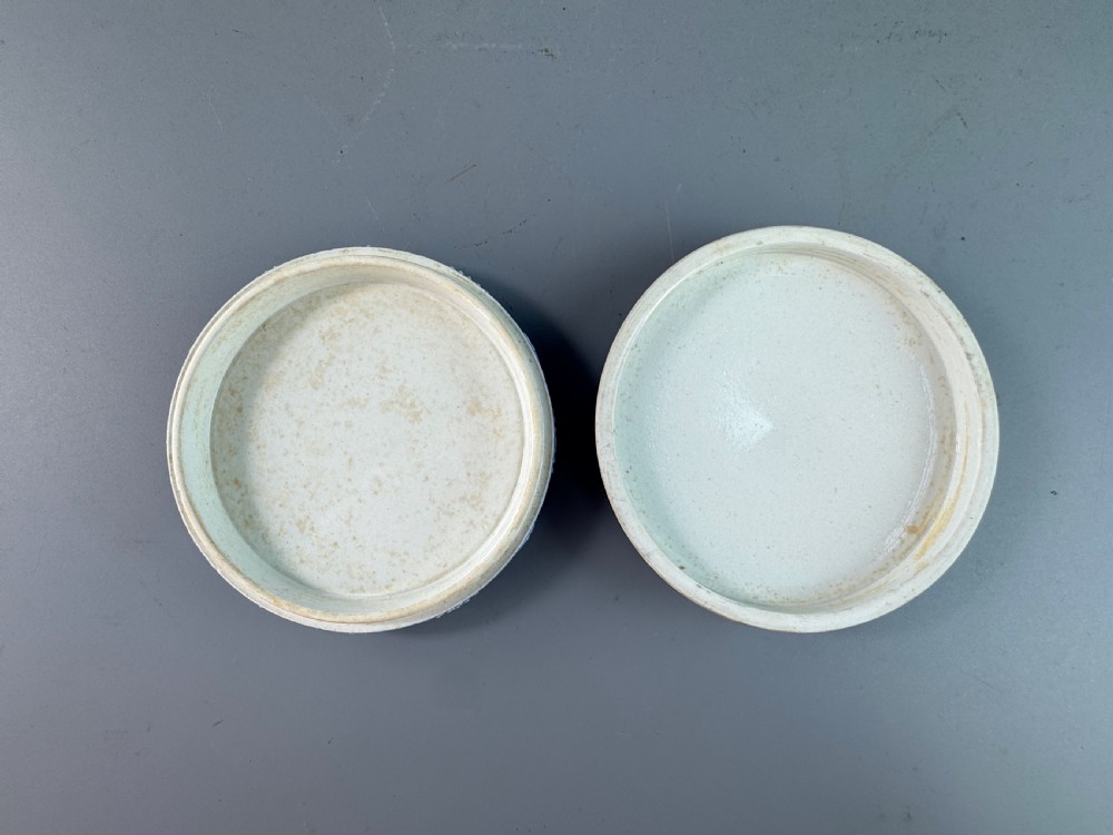 A circular royal blue jasperware patch box featuring white neoclassical relief figures on the lid and floral sprigging around the rim. View V