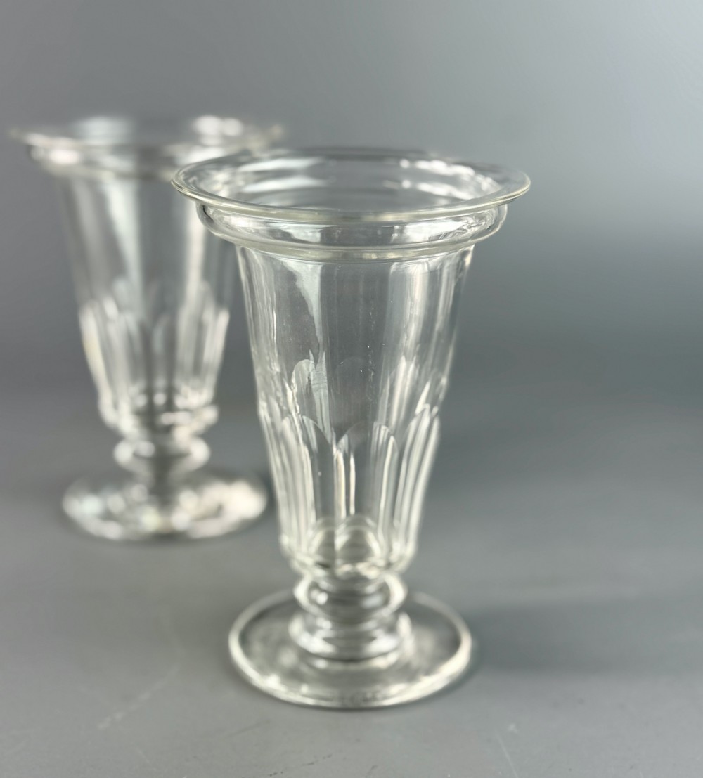 A set of six clear Georgian glass jelly cups featuring fluted tapered bowls, dish tops, knopped stems, and circular bases. View III