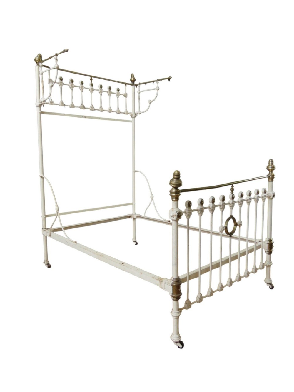 A Victorian off-white painted cast iron half tester double bed featuring brass finials, vertical decorative spindles, and an upper canopy frame over the headboard.