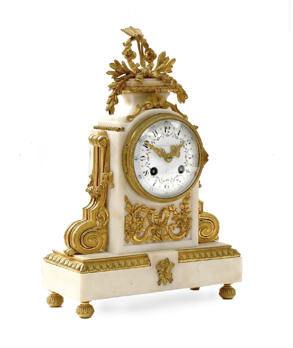A late 19th-century French gilt bronze and white marble mantel clock garniture set flanked by two matching two-light candelabra. View II
