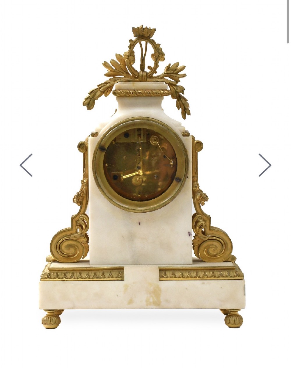 A late 19th-century French gilt bronze and white marble mantel clock garniture set flanked by two matching two-light candelabra. View IV