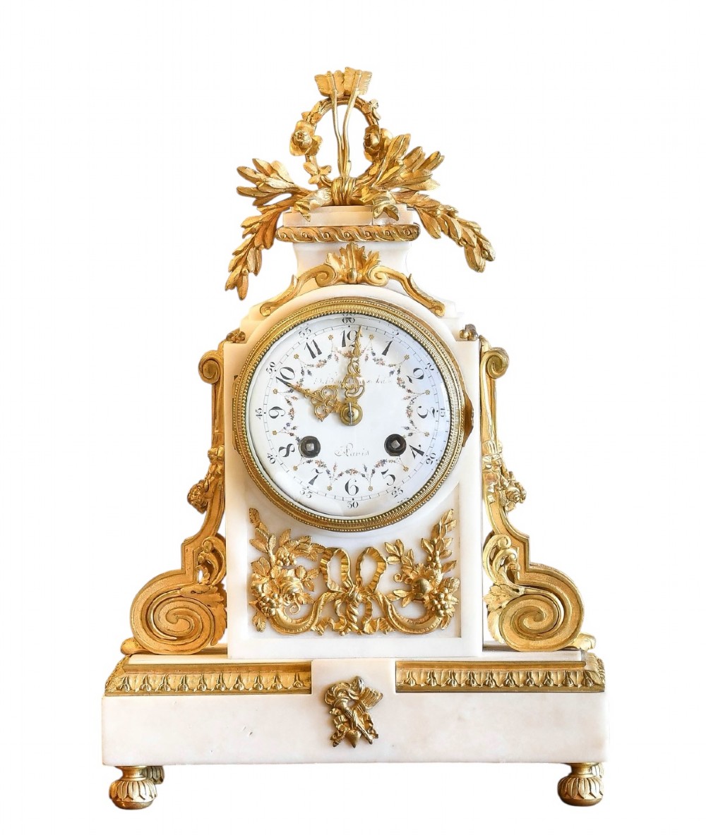 A late 19th-century French gilt bronze and white marble mantel clock garniture set flanked by two matching two-light candelabra. View VIII