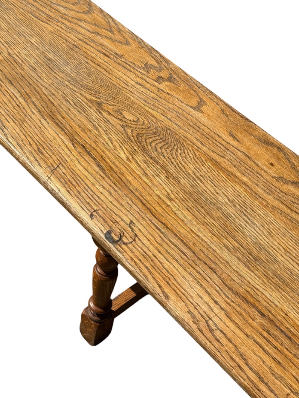 An exceptionally long rustic antique oak bench featuring a smooth rectangular seat, turned legs, and low connecting stretchers. View VII