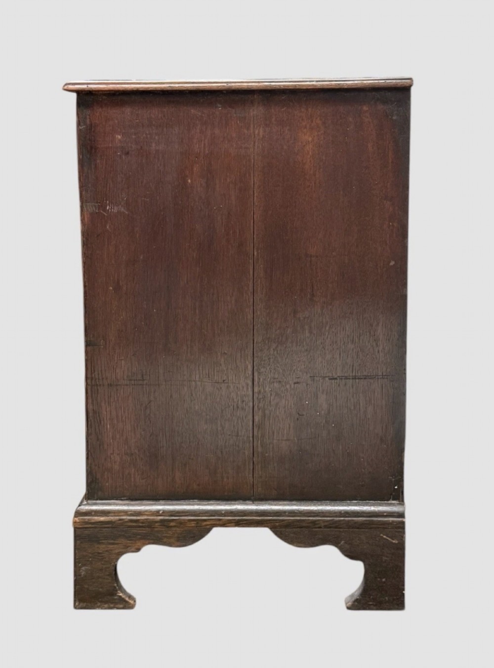 An eighteenth century dark oak chest of drawers featuring two short drawers over two long drawers with turned wooden knobs and bracket feet. View VI
