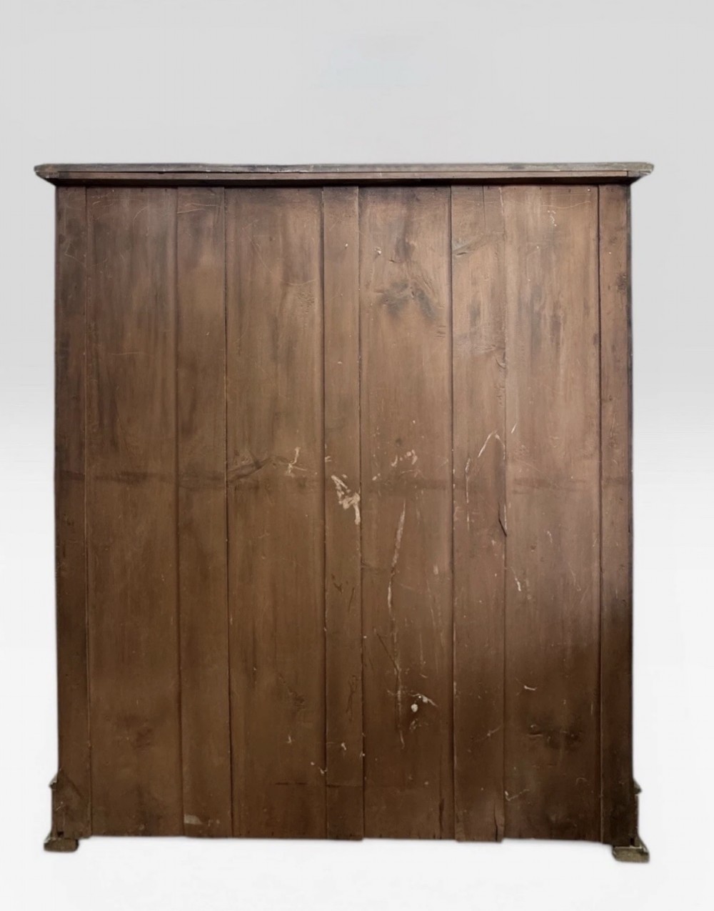 A tall Victorian mahogany chest of drawers featuring two short drawers above four long drawers with brass drop handles and a plinth base. View V