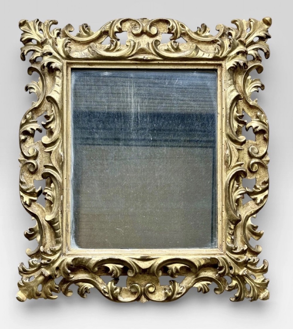 A pair of 19th-century rectangular Florentine wall mirrors featuring intricately carved giltwood frames with openwork scroll and acanthus leaf details. View III