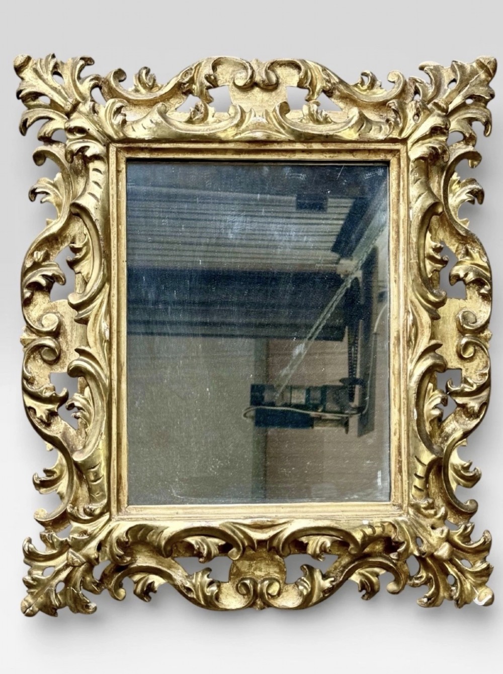 A pair of 19th-century rectangular Florentine wall mirrors featuring intricately carved giltwood frames with openwork scroll and acanthus leaf details. View IV