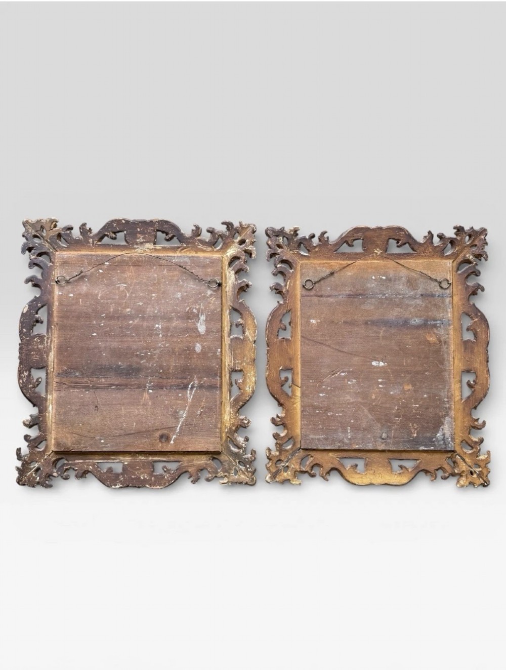 A pair of 19th-century rectangular Florentine wall mirrors featuring intricately carved giltwood frames with openwork scroll and acanthus leaf details. View V