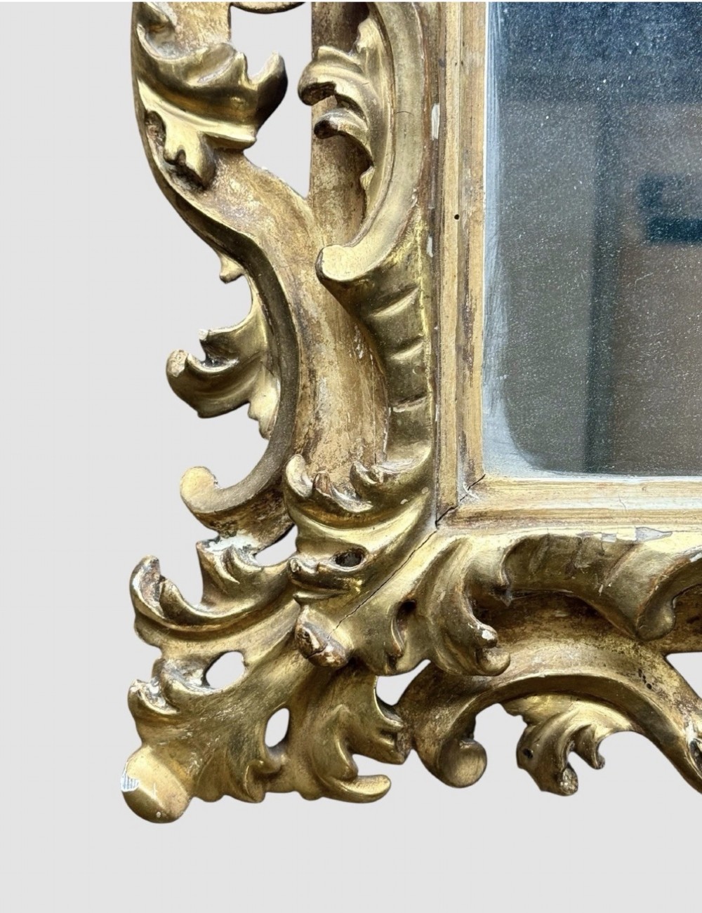 A pair of 19th-century rectangular Florentine wall mirrors featuring intricately carved giltwood frames with openwork scroll and acanthus leaf details. View VI