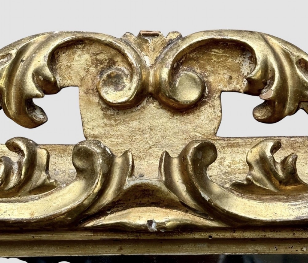 A pair of 19th-century rectangular Florentine wall mirrors featuring intricately carved giltwood frames with openwork scroll and acanthus leaf details. View VII