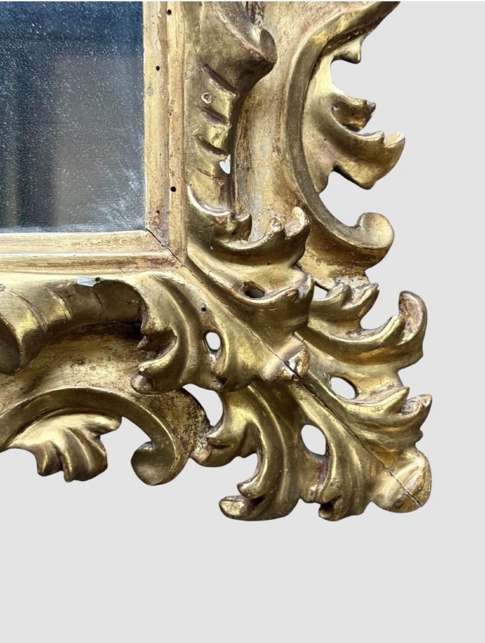 A pair of 19th-century rectangular Florentine wall mirrors featuring intricately carved giltwood frames with openwork scroll and acanthus leaf details. View VIII