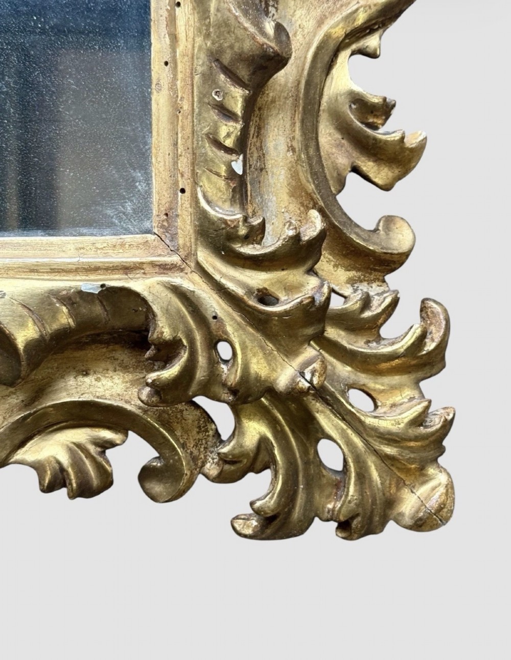 A pair of 19th-century rectangular Florentine wall mirrors featuring intricately carved giltwood frames with openwork scroll and acanthus leaf details. View IX