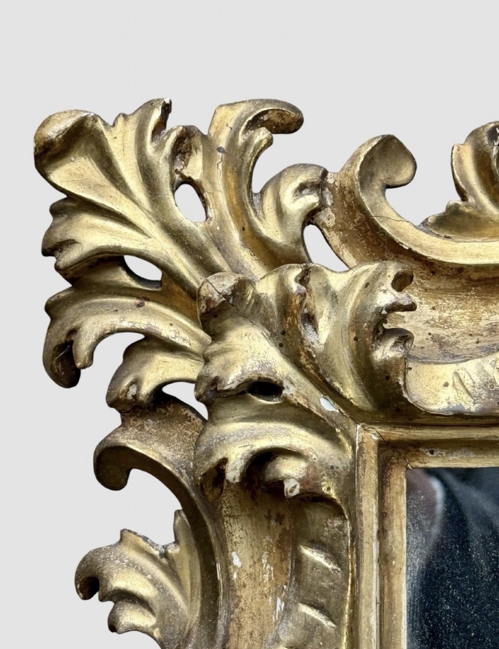 A pair of 19th-century rectangular Florentine wall mirrors featuring intricately carved giltwood frames with openwork scroll and acanthus leaf details. View X