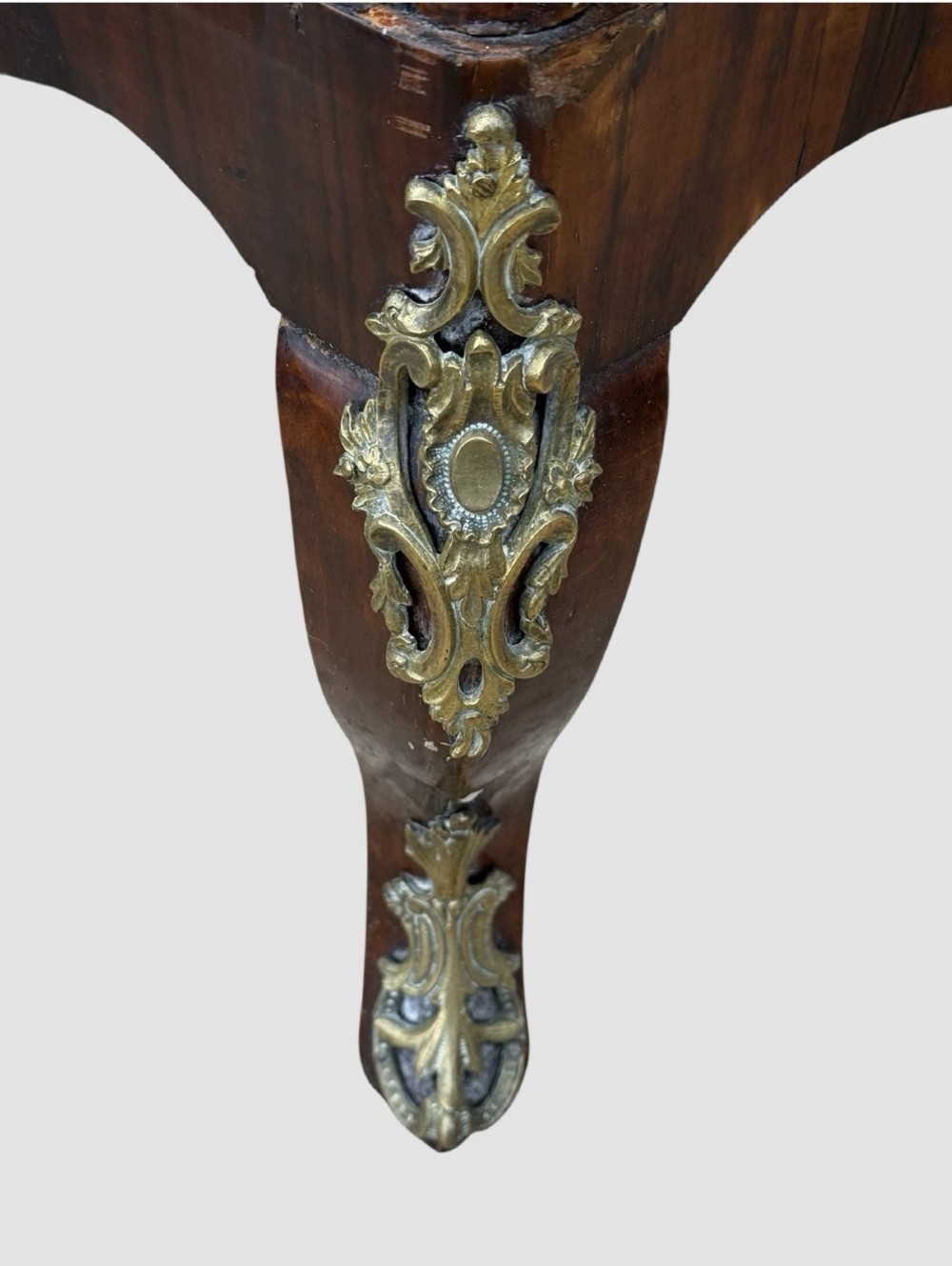A nineteenth-century walnut etagere featuring open serpentine shelves, patterned wood veneers, ornate gilt metal mounts, and cabriole legs. View VIII