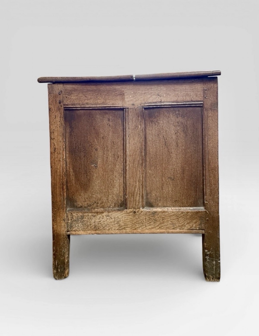 An antique 18th-century oak coffer featuring a three-panel front design and a central iron escutcheon lock plate. View V