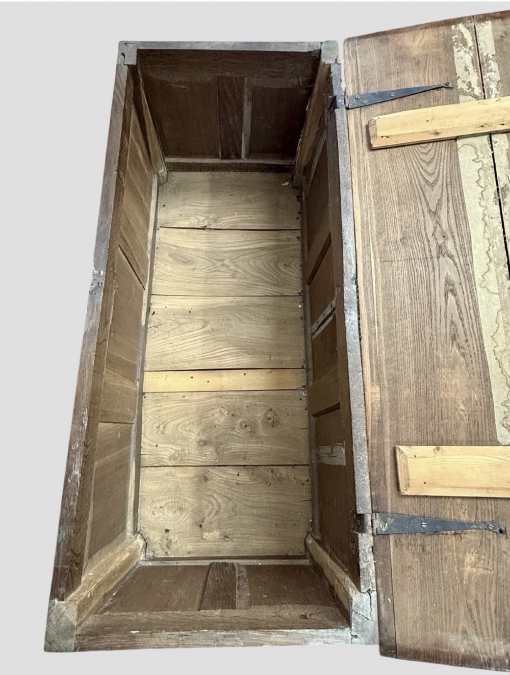 An antique 18th-century oak coffer featuring a three-panel front design and a central iron escutcheon lock plate. View VI