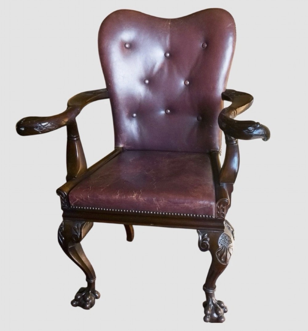 Victorian mahogany library armchair upholstered in button-backed brown leather with carved cabriole legs and claw and ball feet. View II