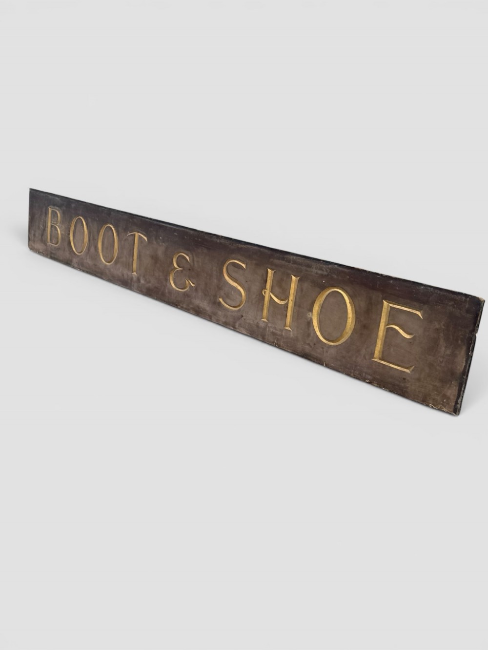 A long rectangular dark wooden sign with incised serif letters spelling DEPARTMENT gilded in gold leaf. View IX