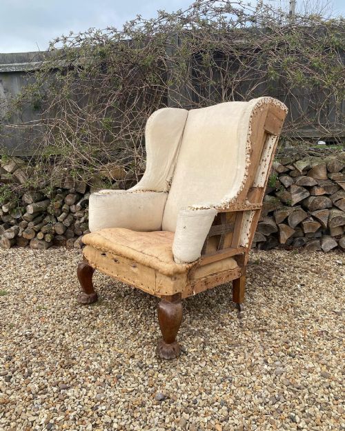 a large scale carved oak wing chair - CATEGORY: ANTIQUE CHAIRS - DATED 19TH CENTURY