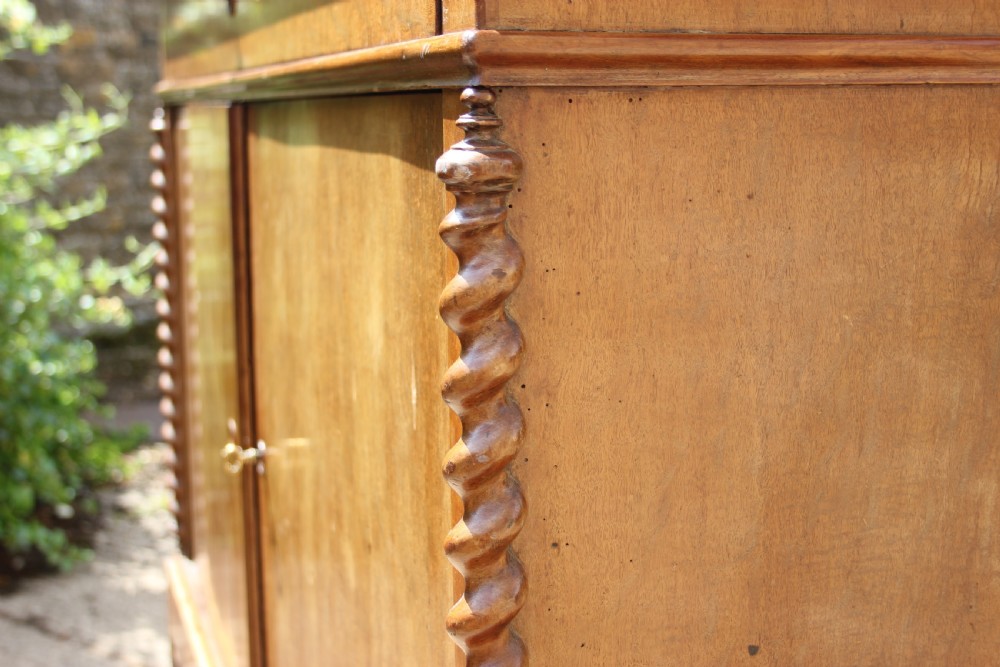 A 19th-century French walnut secretaire featuring a dark marble top, a top drawer, double cupboard doors flanked by spiral twist columns, and scroll feet. View IV