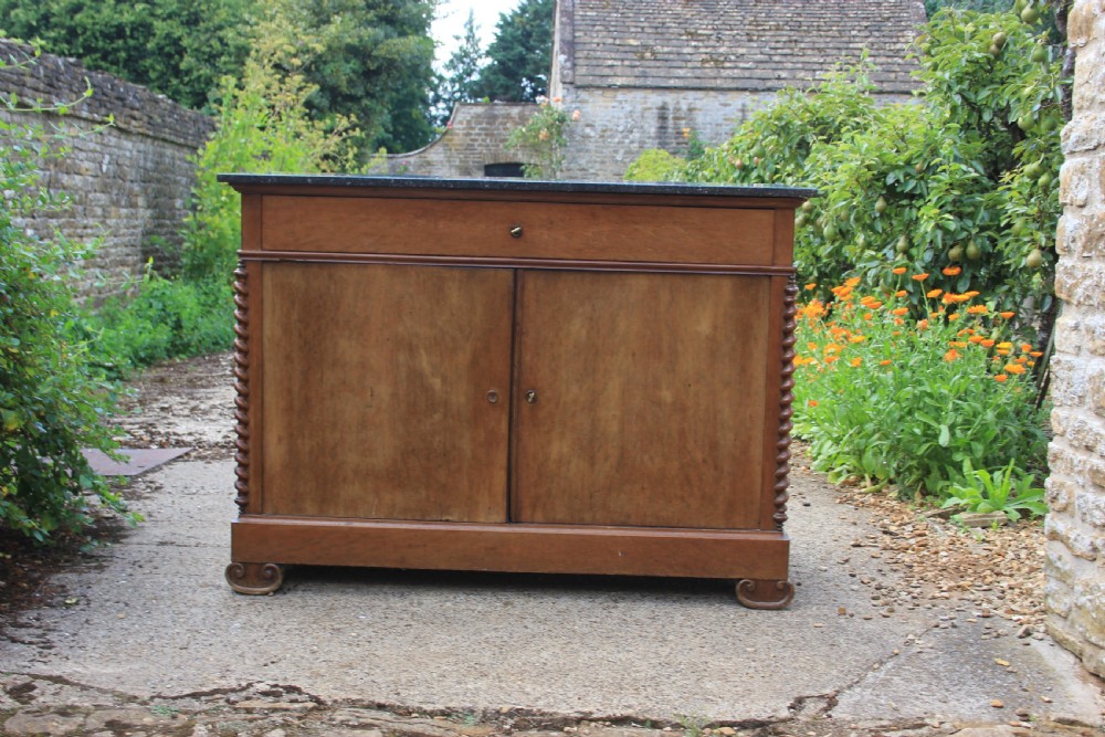 A 19th-century French walnut secretaire featuring a dark marble top, a top drawer, double cupboard doors flanked by spiral twist columns, and scroll feet. View X